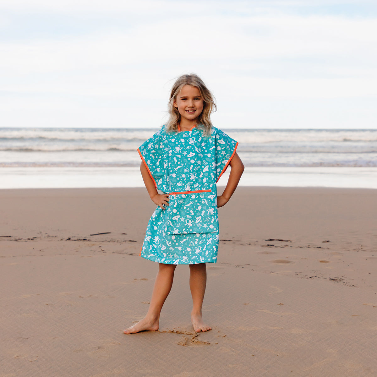 Kids beach poncho towel for travel, holidays and camping | neon orange Hooded Owls Ltd Kids beach poncho towel for travel, holidays and camping | neon orange Hooded Owls Ltd