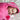 Girl laying on bed smiling snuggled in a pink hooded towel with owl trim