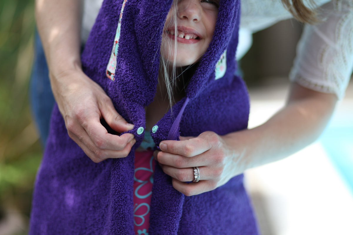 Pop fastener on a hooded towel