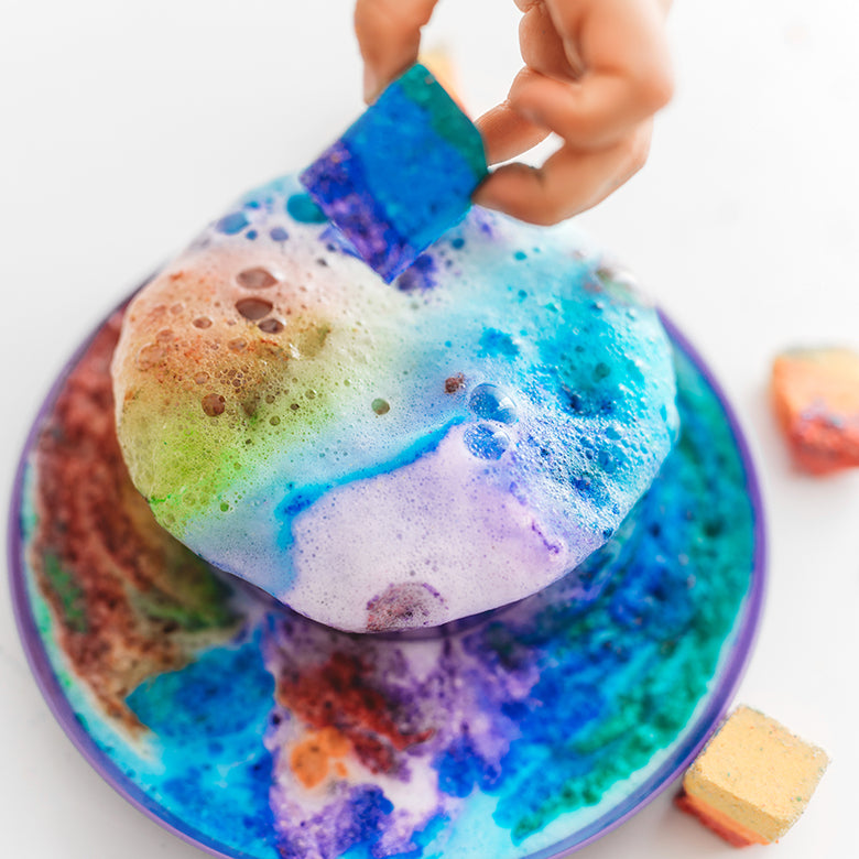 Hands holding colourful bath glitter