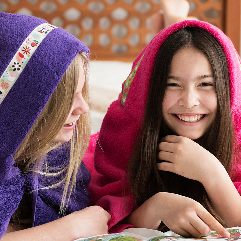 Children wearing Hooded Owls towels