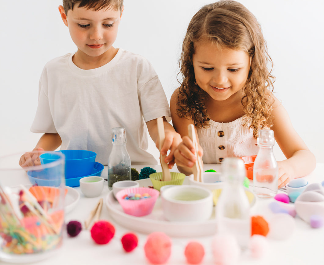 Two children using tongs and tools to make potions