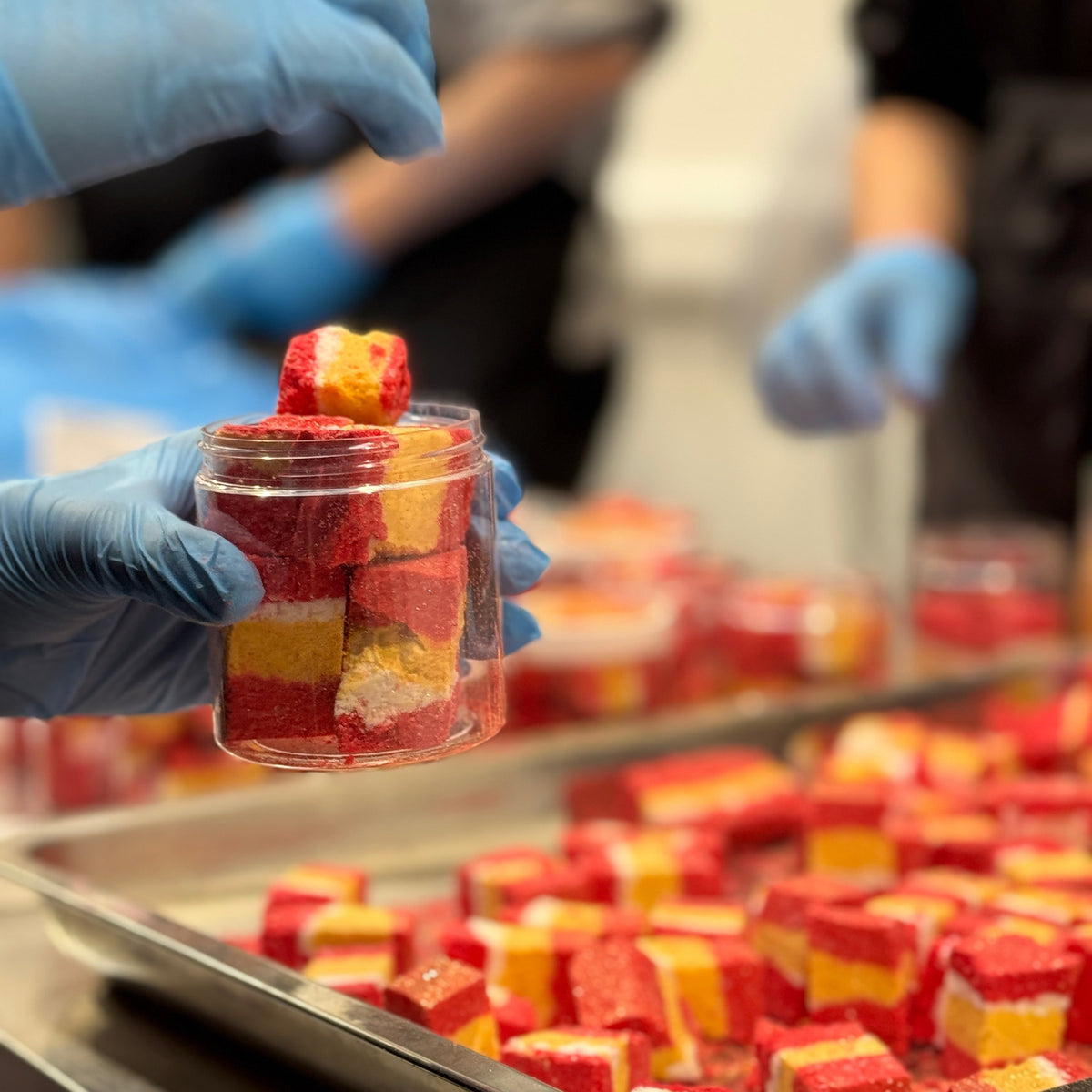 Production team hand-making bath red and yellow bath bomb rocks