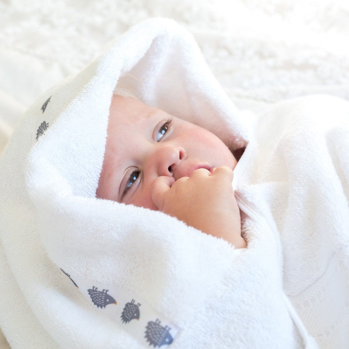 Toddler wearing a hooded towel
