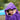 Child sat on a chair in the garden peeking out from under a purple hooded towel with Enchanted Wood Trim