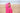Child stood on sandy beach wear pink hooded towel with unicorns trim